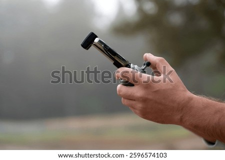 Remote control drone, close-up. Transmitter for controlling moving device in male hands, blurred nature background. Electronics, hobby, aeromodelling concept