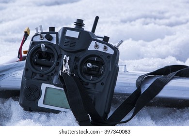 remote control for quadrocopter unmanned aerial vehicle in snow in their hands. aeromodelling