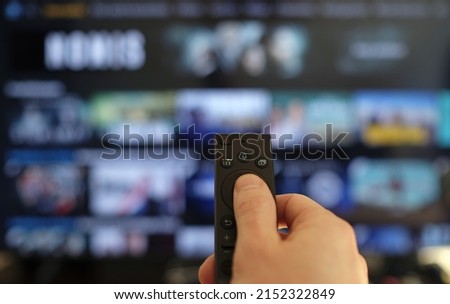 Remote control and screen - binge watching the favorite TV show