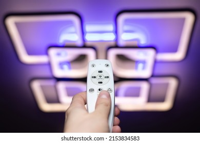 Remote control that controls the light. Neon chandelier on the ceiling.