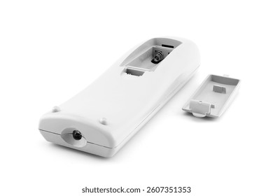 remote control, view from the battery compartment, back cover removed and lying nearby, designed to control home entertainment systems and TV, close-up on a white background