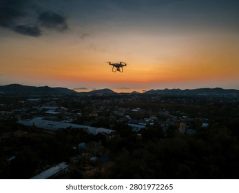 Remote controlled drone operating over the city during golden hour.