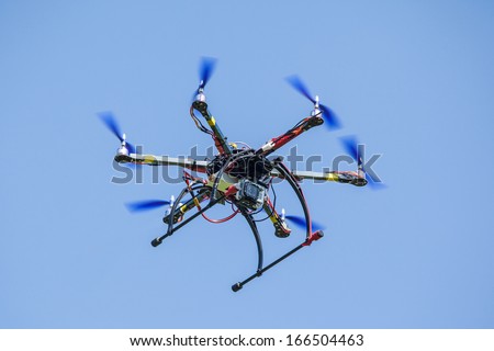 Remote drone flying with video camera on board.
