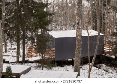 Remote elevated lodge surrounded by snow and rocky terrain