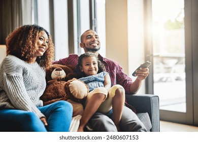 Remote, happy and child watching movie with parents in living room for bonding, fun and family time. Relax, love and girl kid streaming film, show or tv with mother and father in lounge at home. - Powered by Shutterstock