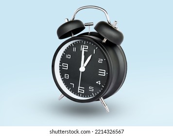 remote image of The black alarm clock is set to 1:00 a.m. a blue background.
