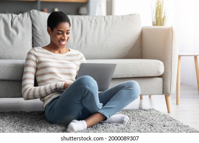 Remote Job Opportunities. Happy Black Woman Working With Laptop At Home, Positive Young African American Freelancer Lady Using PC Computer While Sitting On Floor In Living Room, Copy Space