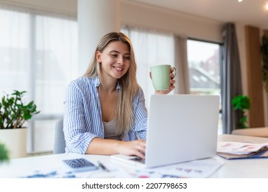 Remote Job, Technology And People Concept - Happy Smiling Young Business Woman With Laptop Computer And Papers Working At Home Office