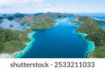 A remote lagoon, surrounded by limestone islands, protects a vibrant and diverse coral reef in Wayaq Island, Raja Ampat, Indonesia.