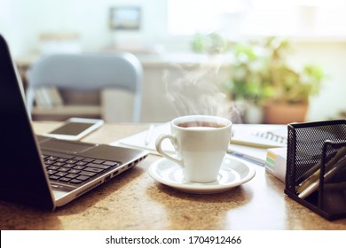 Remote Learning Or Work. Closeup Tea Cup On A Home Table With A Laptop.  Break Time Concep