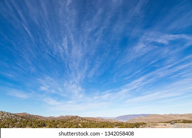 A Remote Road In The Nevada Desert, With A Vast Sky Overhead