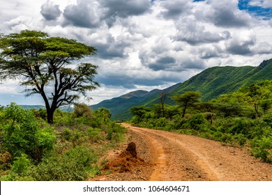 Remote rural area near Siracho Escarpment, Baringo County, Kenya looking across the Great Rift Valley. The rough dirt road is rocky and off the beaten track. Storm brewing. Natural landscape scenery. 