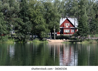 Remote summerhouse with reflection on the lake - Powered by Shutterstock