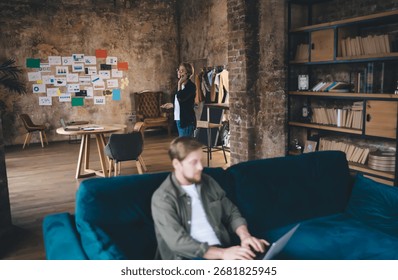 Remote tech worker types on laptop, immersed in digital task flow while maintaining calm focus in relaxed startup environment, illustrating concentration in virtual workflow.