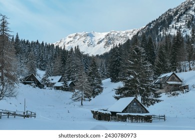 Remote village of wooden cottages at Seeberg Pass in Muerzsteg Alps, Styria, Austria. Panoramic view of snow capped mountain peak Hochschwab. Winter wonderland remote Austrian Alps. Idyllic forest - Powered by Shutterstock