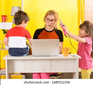 Remote work from home with kids. Parents work on laptop with children playing around. Children make noise and disturb mom at work. Busy mother 