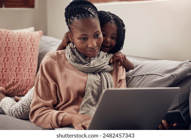 Remote work, laptop or mother and girl on sofa for multitasking, parenting and bonding in home productivity. Black family, work life balance and freelance mom with telework pc in living room with kid - Powered by Shutterstock