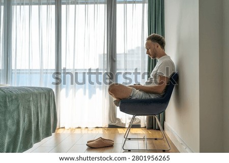 Remote work lifestyle man using laptop in bright apartment room, digital nomad workation, online business, home office interior