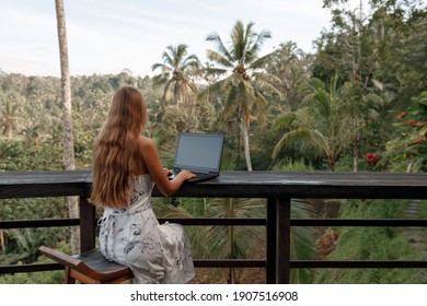 Remote Work In Tropic Country. Woman Working With Laptop Wjile Sit In Cafe With Jungle View, Coconut Palms Around