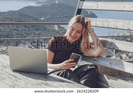 Remote Work,digital nomad enjoys remote work with a laptop in a scenic mountain setting.freedom of location-independent work, online business, and the balance of work and travel.