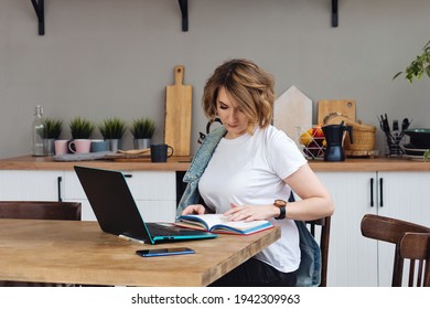 Remote Working From Home. Girl Freelancer Workplace In Kitchen With Laptop. Concept Distance Learning, Self Isolation, Female Small Business, Shopping Online. Lifestyle Moment.