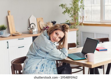 Remote Working From Home. Girl Freelancer Workplace In Kitchen With Laptop, Mug Of Tea Or Coffee. Concept Distance Learning, Self Isolation, Female Small Business, Shopping Online. Lifestyle Moment. 