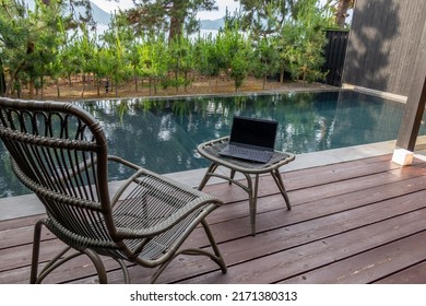 Remote Working At Poolside Terrace With Rattan Furniture