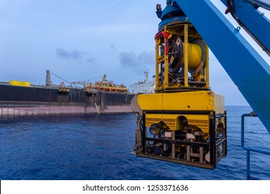 A Remoted Operated Vehicle (ROV) hanging on Launch & Recovery System (LARS) for underwater pipeline survey and inspection nearby Floating Storage Offloading (FSO) vessel.