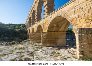 Remoulins , France - August 12, 2016:people Swim And Canoe Near The Pont Du Gard Roman Aqueduct During A Sunny Day