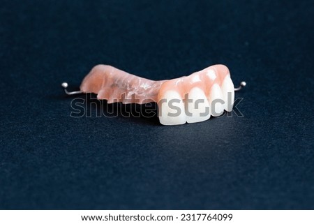 Removable dentures on a dark background