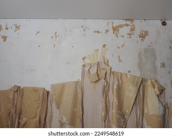 removal of old wallpaper from the wall renovation of the room - Powered by Shutterstock