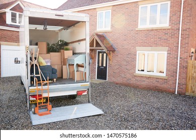 Removal Truck Waiting To Be Unloaded Outside New Home On Moving Day - Shutterstock ID 1470575186
