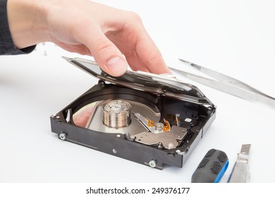 remove the cover from the hard disk on white background