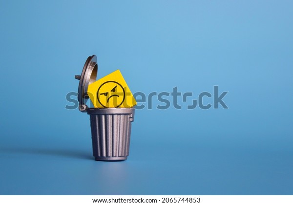Remove negative
thoughts, anger management concept. Wooden cube with angry face
icon inside dustbin, trash
can.
