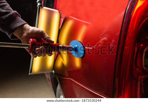 Removing dents on the car. PDR technology. Car\
body repair without\
painting.