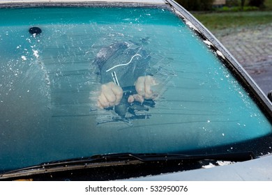 Removing Ice From The Frozen Windshield