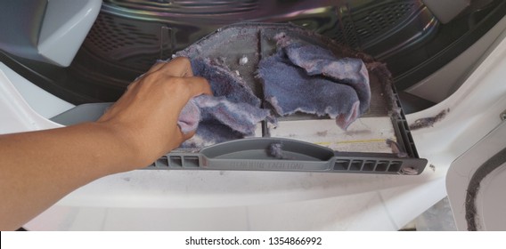 Removing Lint from the dryer and Cleaning the dryer drum with my hands on laundry day.