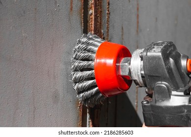 Removing rust from metal. Wire brush on an angle grinder. Cleaning of metal from corrosion. - Powered by Shutterstock