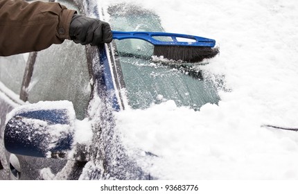 Removing Snow From Car With A Brush