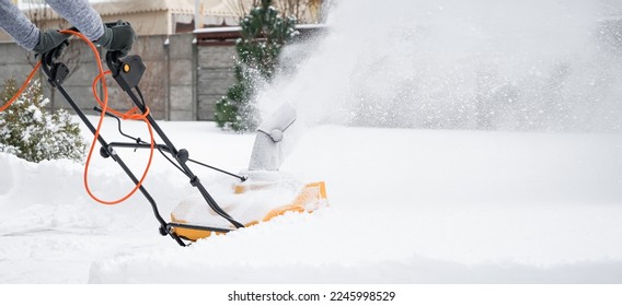 Removing of snow in yard on winter day