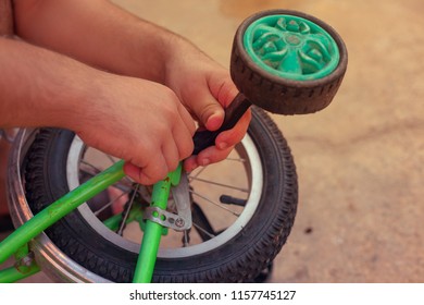 Removing The Training Wheels. Father Repairing His Kids Bicycle.