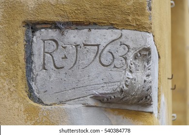 Renaissance cornerstone with date on yellow wall - Shutterstock ID 540384778