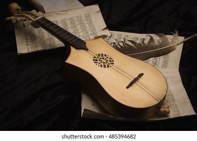 Renaissance lute (citole) with musical notes in retro style.  