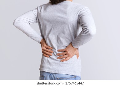 Renal colic and back pain. Man suffers from lower back pain, cropped, studio shot - Shutterstock ID 1757465447