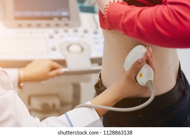 Renal Ultrasound Examination Of Kidneys. Hospital Doctor Examines A Young Woman With Ultrasound.