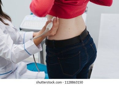 Renal Ultrasound Examination Of Kidneys. Hospital Doctor Examines A Young Woman With Ultrasound.