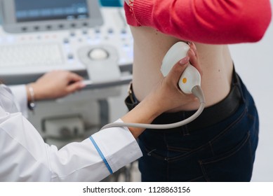 Renal Ultrasound Examination Of Kidneys. Hospital Doctor Examines A Young Woman With Ultrasound.