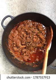 Rendang Daging . Indonesian Spicy Beef Stew Inside Cooking Pan With Grey Background