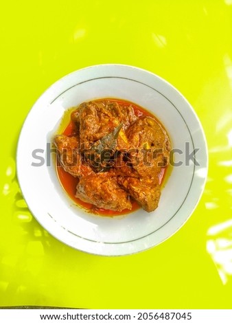 Rendang meat. The dish comes from Padang or West Sumatra which is very popular in Indonesia. isolated on a yellow background