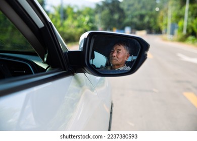 Renew driving license for elderly, travel and old people concept,  Asian senior man driving car. - Powered by Shutterstock